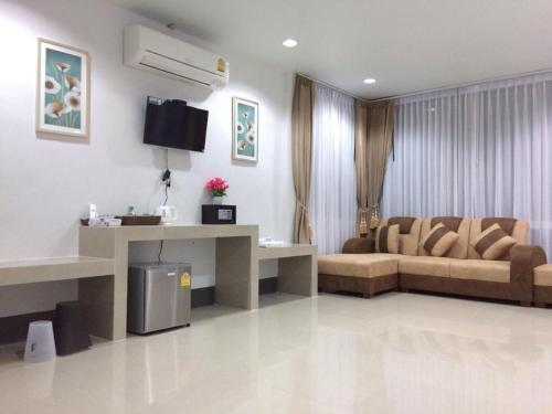 a living room with a couch and a table at The Key Hotel in Ko Lipe