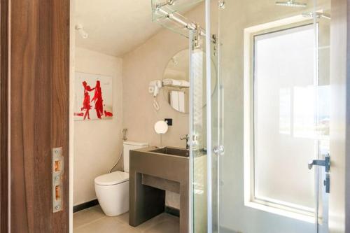 a bathroom with a toilet and a sink and a shower at LYV Boutique Cabana in Marsa Matruh