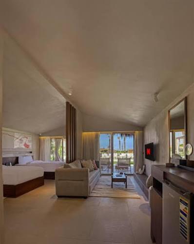 a bedroom with a bed and a living room with a couch at LYV Boutique Cabana in Marsa Matruh