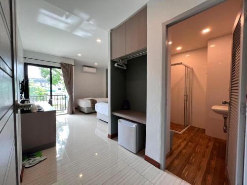 a large room with a bedroom and a bathroom at Baan Nan B&B Hotel in Nan