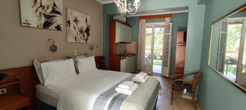 a bedroom with a bed with towels on it at Edem Studios in Syvota