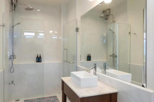 a bathroom with a sink and a shower and a mirror at The La-Ngu Boutique in Langu