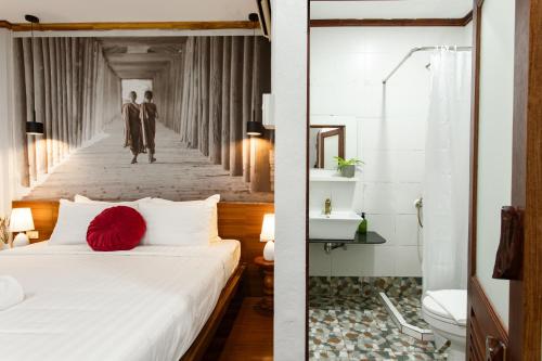 a hotel room with a bed and a bathroom at BlueHome Vientiane in Vientiane