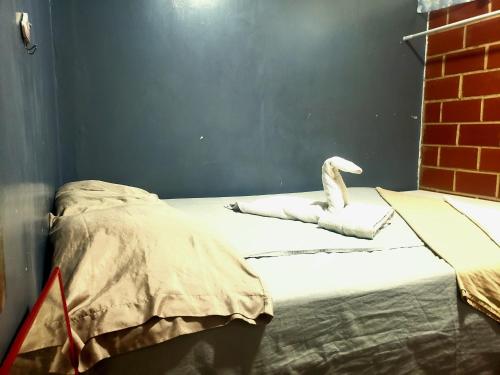 a bedroom with a bed with a white bird on it at Renta Rey David in Caracas