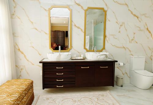 a bathroom with two sinks and a mirror at Jul Rick House Guesthouse in Sandton