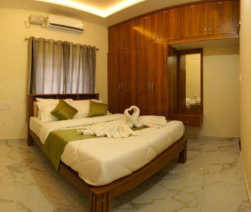 a bedroom with a large bed with a mirror at Gayathri Nest in Udupi