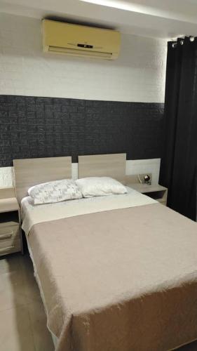 a bedroom with a large white bed in a room at Terramia Suite in Cabudare