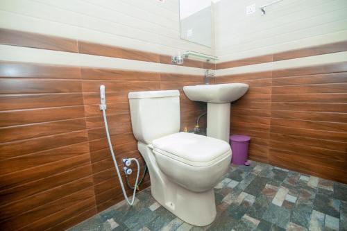 a bathroom with a toilet and a sink at Zenvora Rainforest Villa in Deniyaya