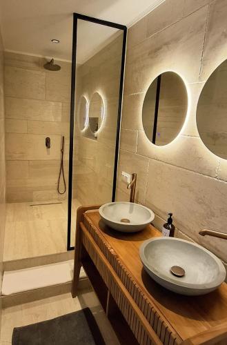 a bathroom with two sinks and a shower at Villa Alexa in Gaios