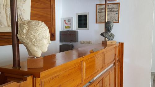 a museum with a bust on top of a wooden table at Varmy in Ierápetra