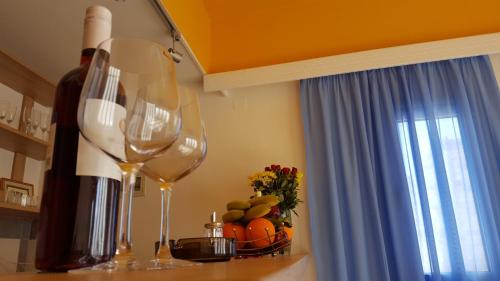 two wine glasses sitting on a counter next to a window at Varmy in Ierápetra