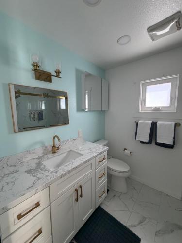 a bathroom with a sink and a toilet at Two Bedroom Beach Apartment in Sunset Beach
