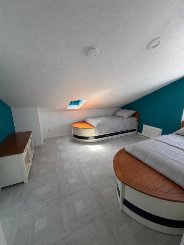 a bedroom with two beds and a table in it at Two Bedroom Beach Apartment in Sunset Beach