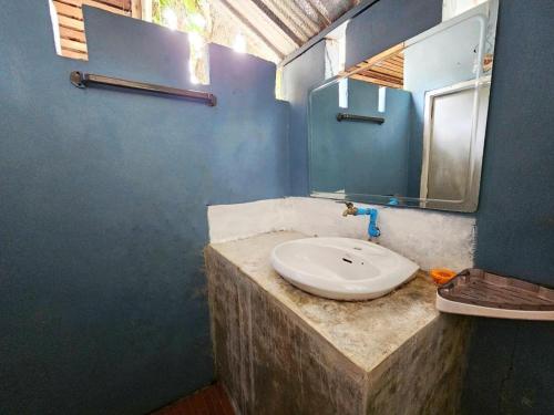 a bathroom with a sink and a mirror at Longbeach Kohphayam in Ko Phayam