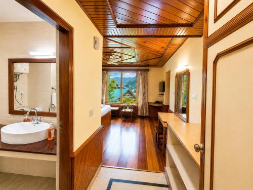 a bathroom with a sink and a mirror at Royal Kalinga Cottage near volvo bus stand, Manali - Best Property of Manali 2025-26 in Manāli