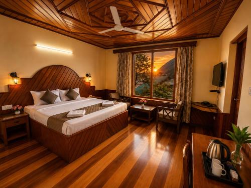 a bedroom with a large bed and a large window at Royal Kalinga Cottage near volvo bus stand, Manali - Best Property of Manali 2025-26 in Manāli