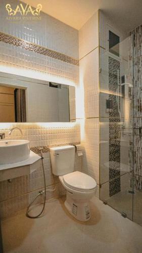 a bathroom with a toilet and a sink and a shower at Aiyara Riverine Hotel, Nakhon Phanom in Ban Nong Puk