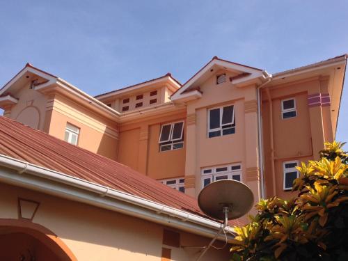 a building with a satellite dish on the roof at J residence Motel in Entebbe