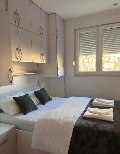 a bedroom with two beds and a window at Katarina in Kaštela