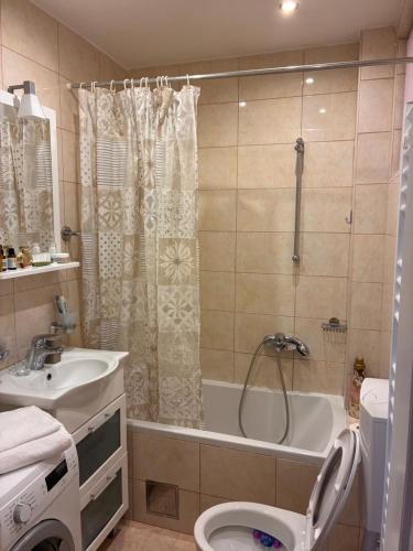 a bathroom with a tub and a toilet and a sink at Katarina in Kaštela