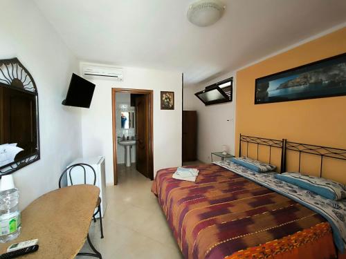 a bedroom with a bed and a table and a table at b&b Bellavista in Castro di Lecce