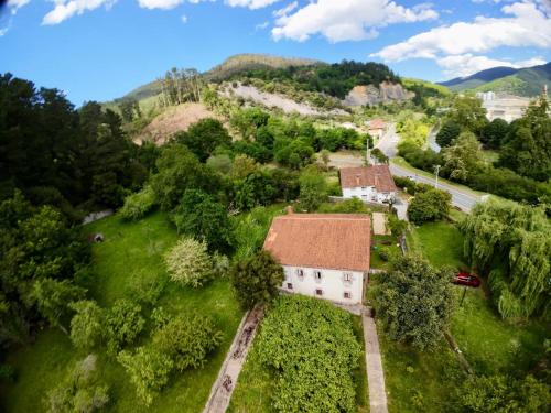 an aerial view of an old house on a hill at Lutzin Etxea, Caserío Vasco con piscina, jardín y parking, a 15 min de Bilbao in Llodio