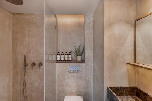 a bathroom with a shower with a toilet and a sink at The ABY in Tel Aviv