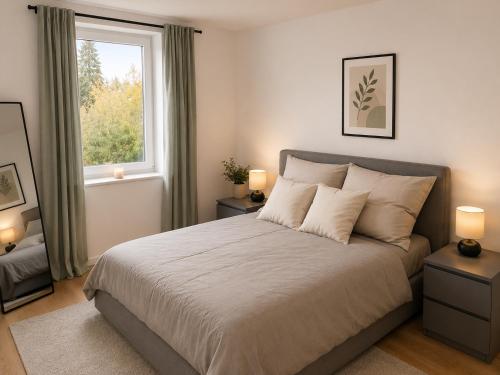 a bedroom with a large bed and a window at Apartment -Wohnung Herford in Herford