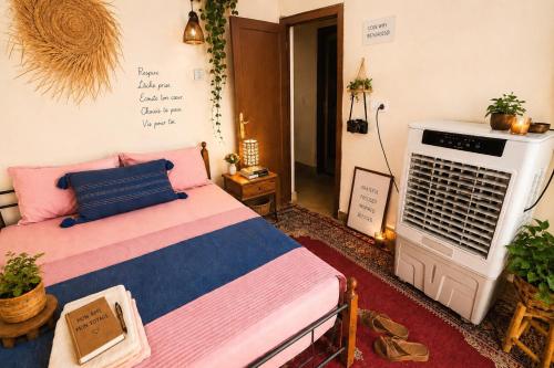 a bedroom with a bed and a air conditioner at Studio in City Center Living at Heart of It All, 200 m away from CTM in Er Rachidia