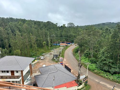 an overhead view of a road next to a house at Satkar Comforts in Attigundi