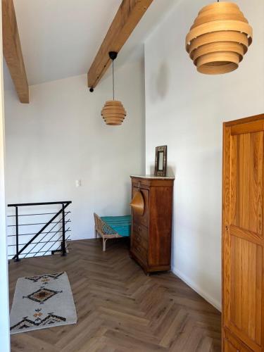 a room with a wooden floor and two pendant lights at Charming loft in Cozzano in Cozzano