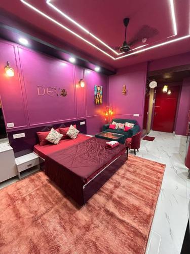 a bedroom with a large bed and purple walls at THE MOONLIGHT STUDIo in Ghaziabad
