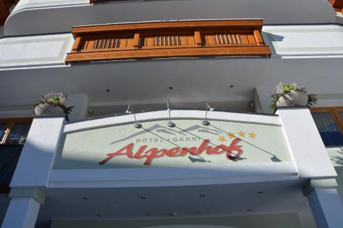 a sign on the side of a building at Hotel Garni Alpenhof in Ischgl