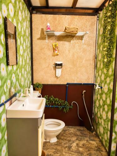 a bathroom with a toilet and a sink at SABAYA HOMESTAY in Balik Pulau