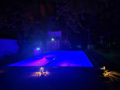 an empty swimming pool lit up at night at Karibu Paradaizi in Michamvi