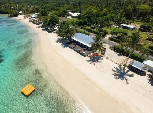 an overhead view of a beach with a building and the water at Lauiula Beach Club in Pu‘apu‘a