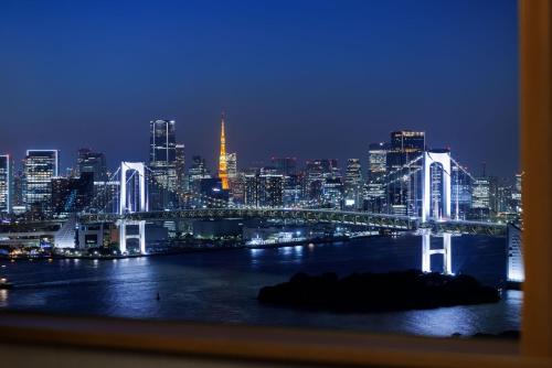 a view of a city at night with a bridge at Grand Nikko Tokyo Daiba in Tokyo