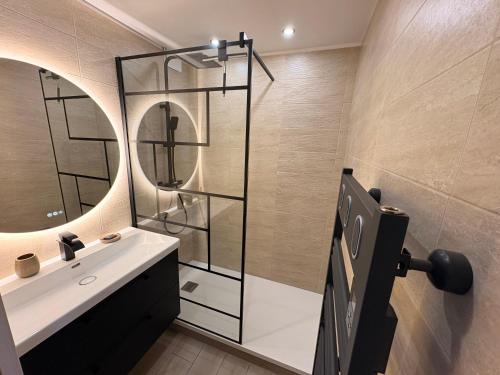a bathroom with a sink and a mirror at T2 "Bohême" vue mer, centre ville tout à pied in Le Lavandou