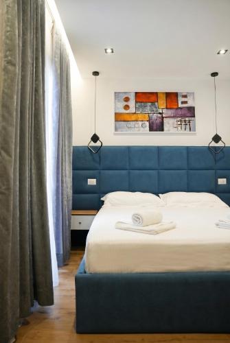 a bed with a blue headboard in a room at Blue Heaven Seaside in Borsh