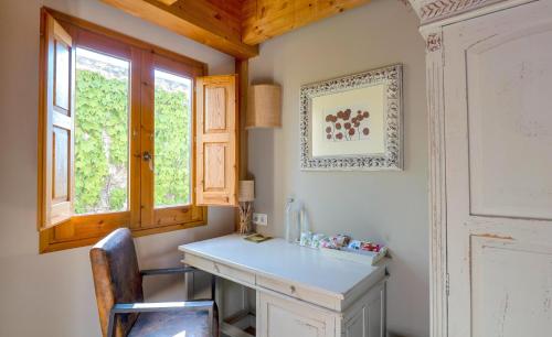 a home office with a desk and a window at Hotel Boutique Niu de Sol - Designed for Adults in Palau-Saverdera