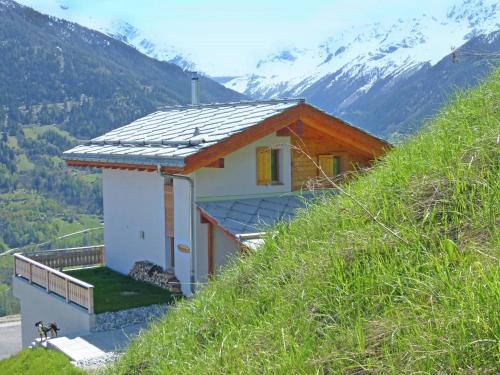 a small house on the side of a hill at Chalet in Heremence with Stunning Alpine Views in Hérémence