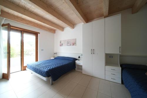 a bedroom with a bed and a sink and a mirror at Bibione MasterVillage Family in Bibione