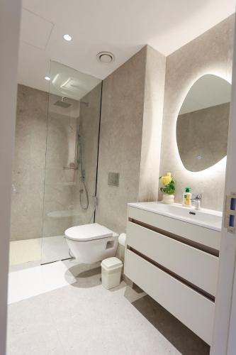 a bathroom with a toilet and a sink and a shower at Diane Homes Evoque nyali in Mombasa