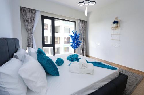 a bedroom with a bed with towels on it at Diane Homes Evoque nyali in Mombasa