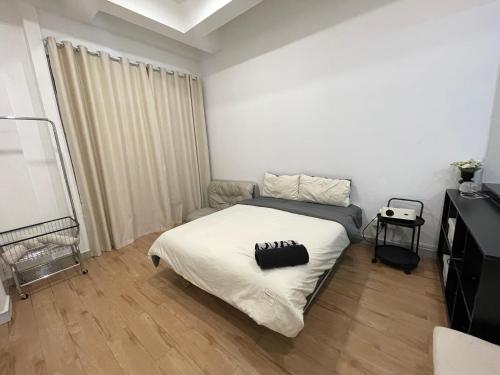a small bedroom with a bed and a television at Amin Studio Apartment Pool And Netflix in Gua Musang
