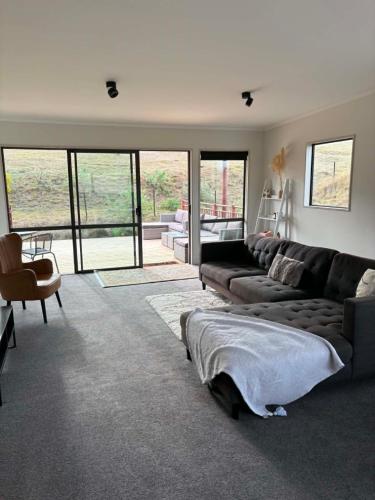 a living room with a couch and a chair at Clydesvale Apartment in Clyde