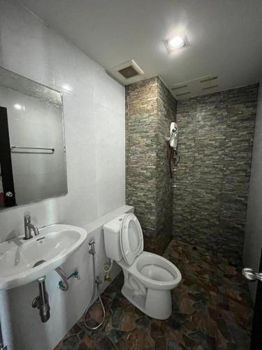 a bathroom with a toilet and a sink at Sixty-Sixplace in Ban Khok Lo