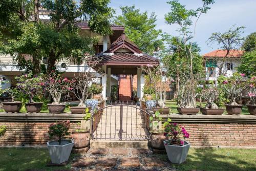a gate in front of a house with potted plants at Phuttal Residence in Phra Nakhon Si Ayutthaya