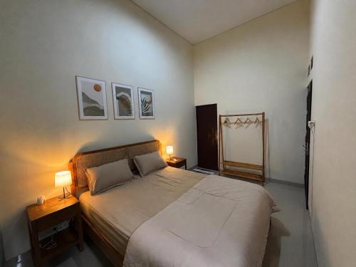 a bedroom with a large bed and two lamps at Secretspot Yogyakarta in Yogyakarta