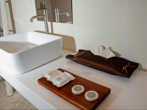 a bathroom with a sink and a wooden tray with towels at Red Z The Ocean in Ban Tanot Noi